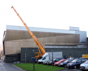Crane lifting Solar equipment to roof